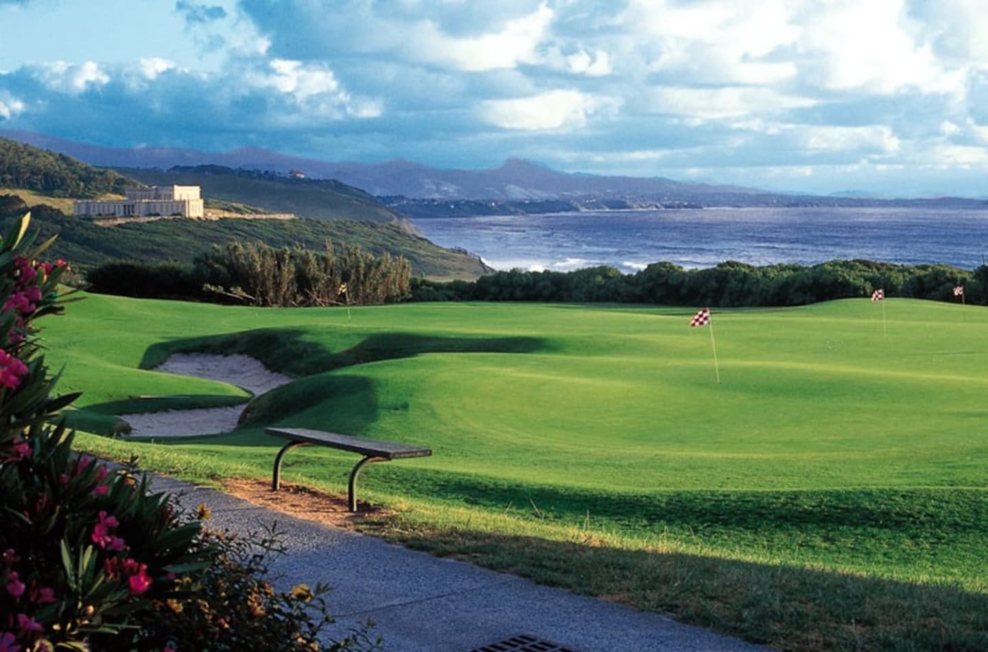 Golf course at Les Chalets Du Lac with lake and mountain views in Clarac, France